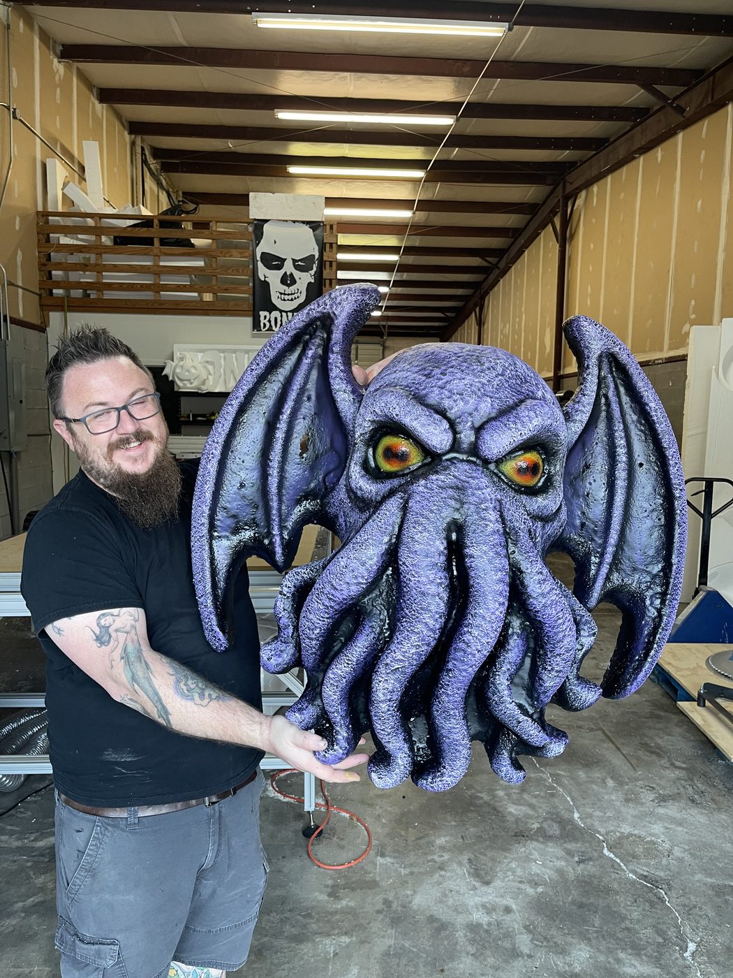 Andrew Bones with a custom creature sculpture